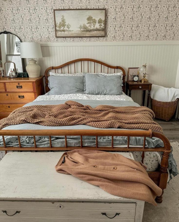 a bed sitting next to a dresser in a bedroom