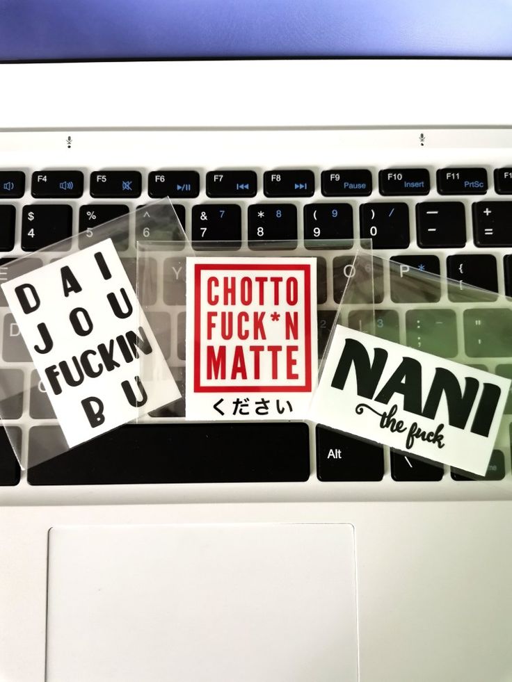 several stickers on the keyboard of a laptop