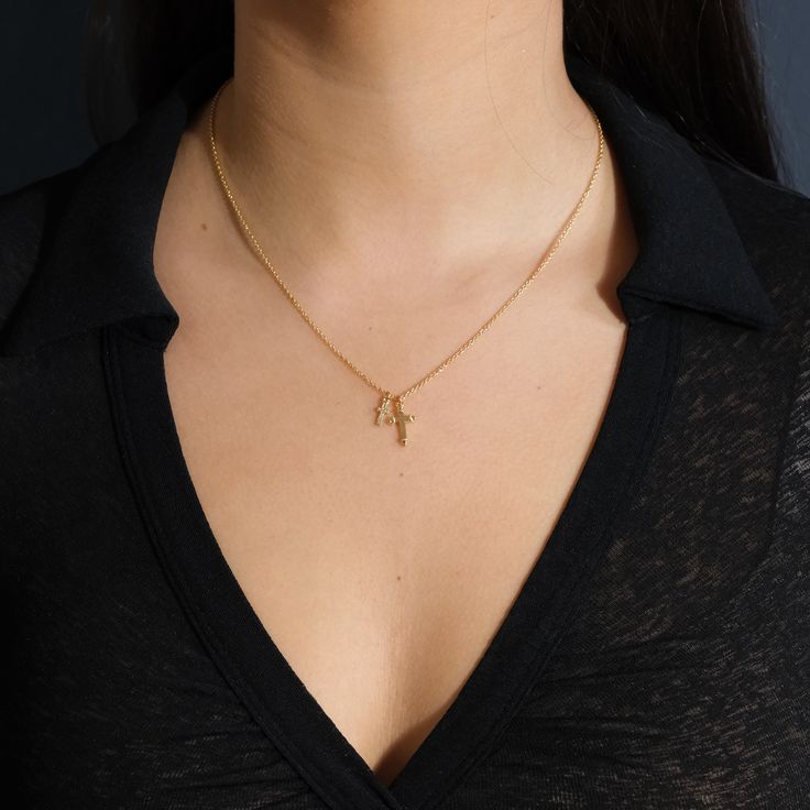 Two beautiful gold cross pendants hang from this delicate chain, giving it a little more flair than a traditional single cross necklace. It's an ideal gift for anyone who's about to celebrate a wedding, a confirmation or a First Communion. Made from high quality materials to last for years to come. Materials: 14K gold plated brass Features: Measures 16" with 2" extender, 10-14mm charms, Lead & Nickel free, lobster clasp Gold Cross Necklace With Delicate Pendant, Elegant Charm Necklace With Cross Pendant And Delicate Chain, Yellow Gold Charm Necklace With Cross Pendant, Yellow Gold Cross Pendant Charm Necklace With Delicate Chain, Gold Plated Cross Necklace With Delicate Chain, Dainty Yellow Gold Cross Necklace With Adjustable Chain, Dainty Gold Cross Pendant Necklace, Elegant Cross Charm Necklace With Adjustable Chain, Yellow Gold Cross Charm Necklace With Delicate Chain