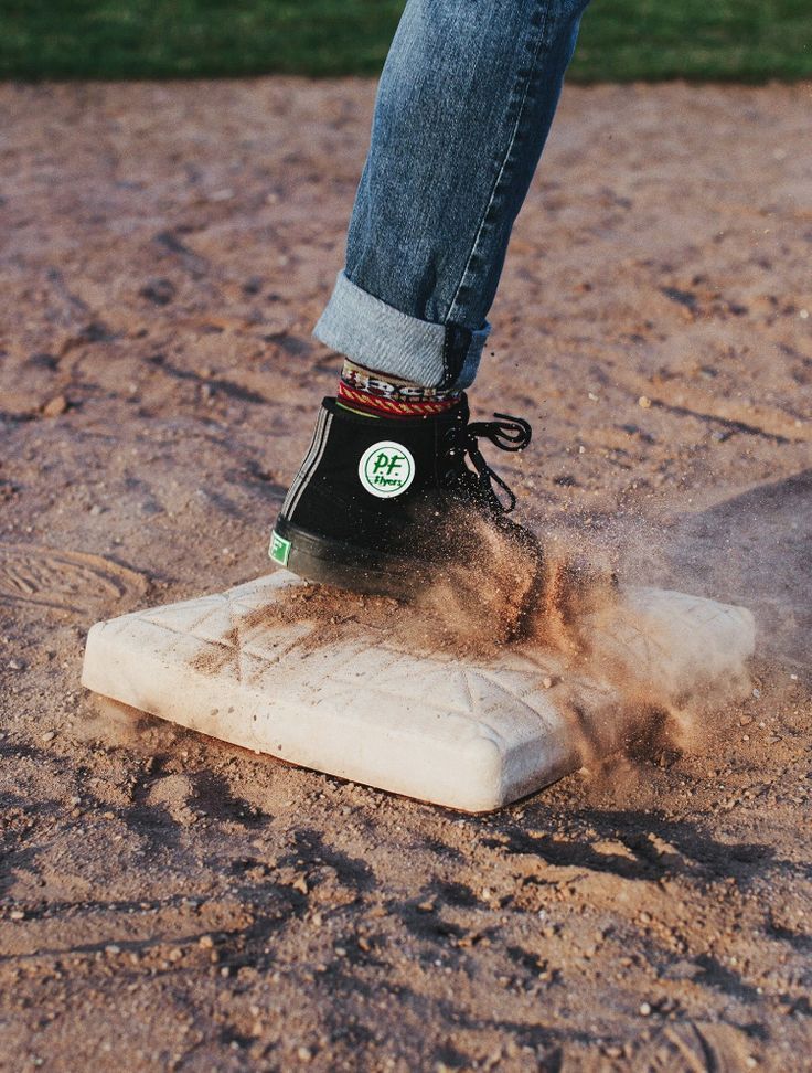 a person standing on top of a stone slab in the middle of dirt and grass