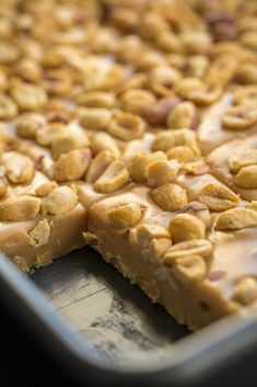 a close up of a tray of food with peanut butter bars on it's side