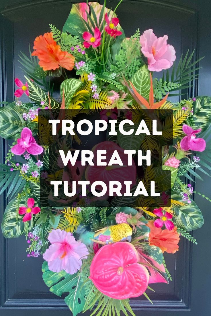 a tropical wreath with flowers and leaves on the front door for an easy diy project