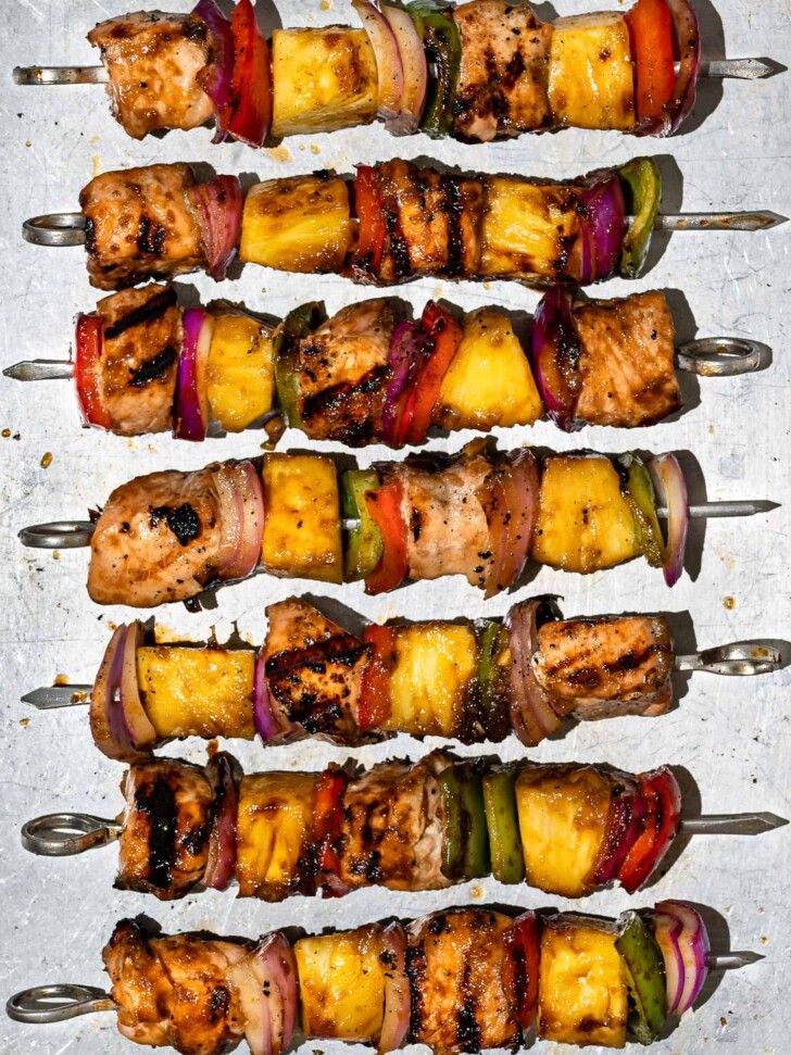 several skewers filled with meat and veggies on top of each other