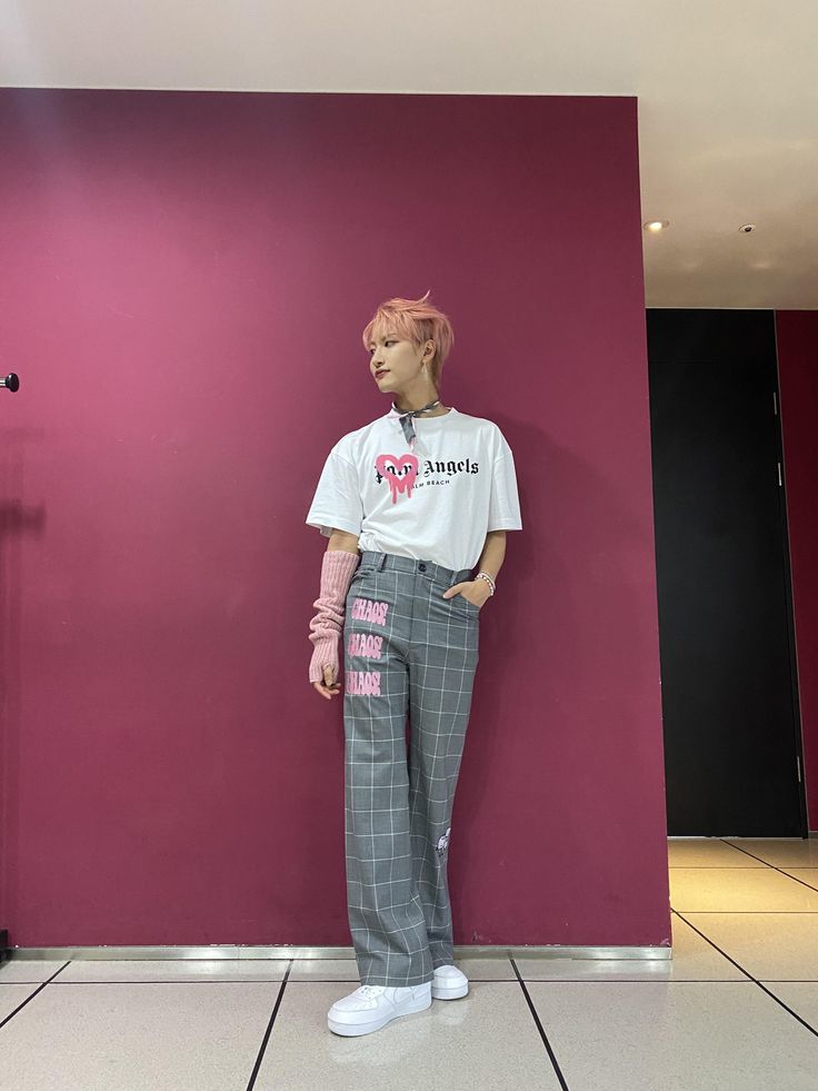 a mannequin is standing in front of a pink wall