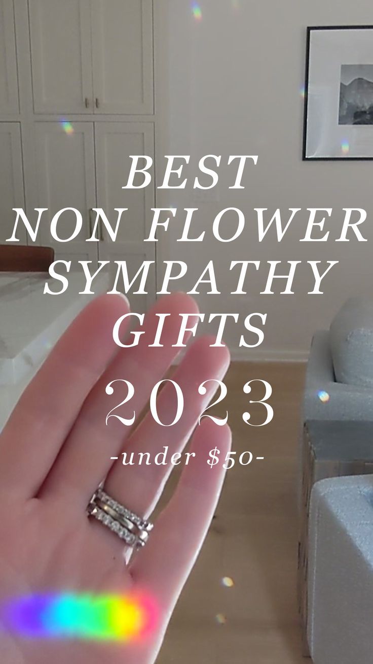 a person's hand holding a ring with the words best non - flower sympathy gifts under $ 50