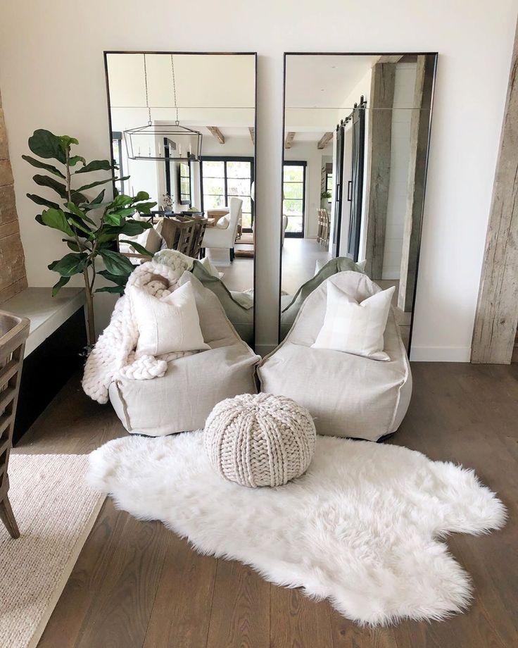 a living room filled with furniture and mirrors