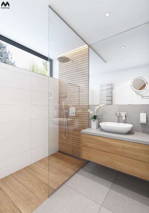 a bathroom with two sinks, a shower and a large mirror on the wall above it