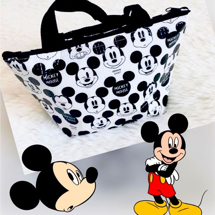 Disney Mickey Mouse Tote Lunch Bag 10.8”X3.9”X6.5”. - Material: Polyester, Expanded Polyethylene, Aluminum - Dry Inside Out After Use - Not Waterproof - Measures 10.8”X3.9”X6.5” Cheap Mickey Mouse Rectangular Bag, Playful Mickey Mouse Bags For Disney Trips, Themed Black Bag With Character Print, Black Themed Bag With Character Print, Playful Bags With Character Print For Everyday Use, Playful Character Print Bags For Everyday Use, Playful Everyday Bags With Character Print, Black Minnie Mouse Bag For Disney Trips, Black Disney Bags With Character Print