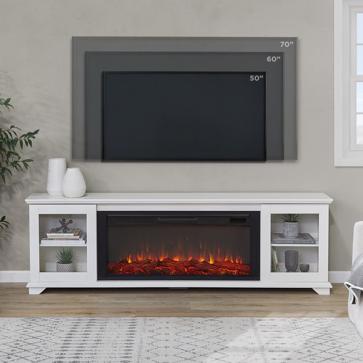 a white entertainment center with a fireplace in the middle and a flat screen tv above it