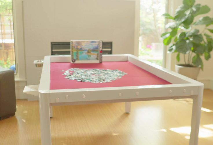 a table with a pink cloth on it in the middle of a room