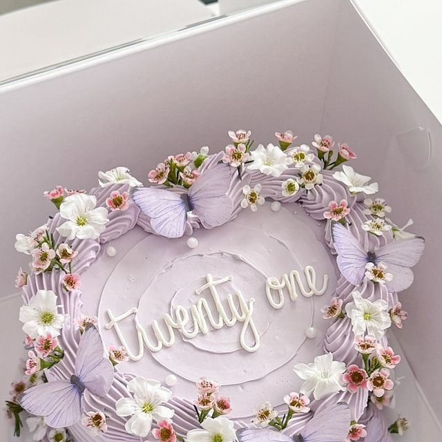 there is a cake in the box decorated with flowers