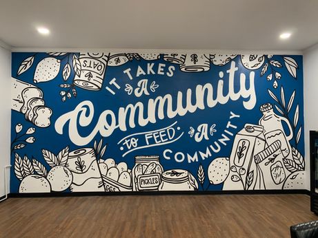 a large mural on the side of a building that says, i takes the community