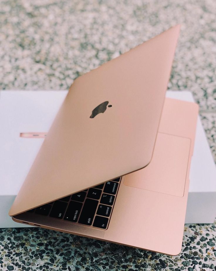 an open laptop computer sitting on top of a white box