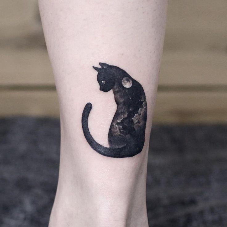 a black cat tattoo on the right leg and foot, with space in the background