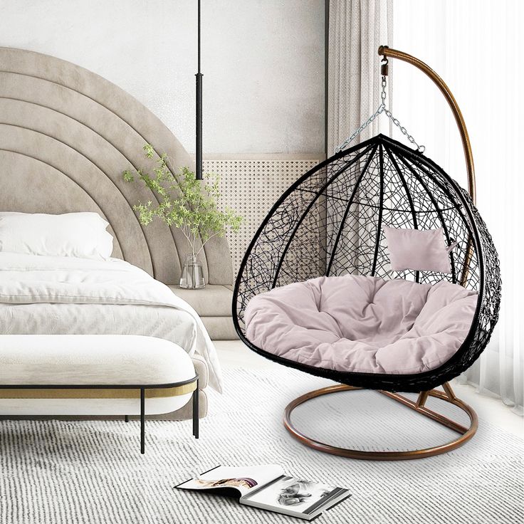 a bedroom with a bed and hanging chair