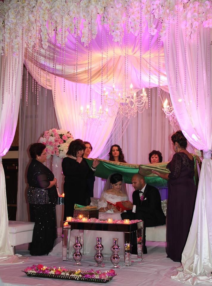 the bride and groom are getting ready to cut their wedding cake at the reception table