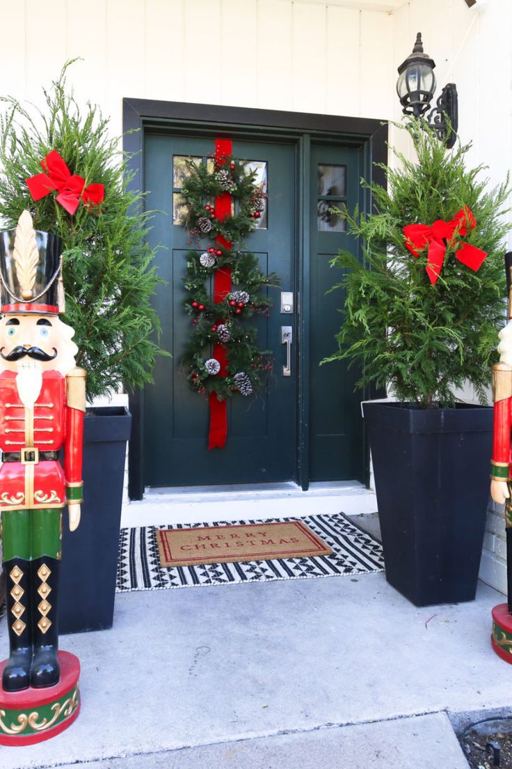 christmas decorations are displayed in front of a door