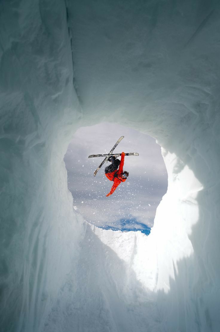 a skier in the middle of an ice cave