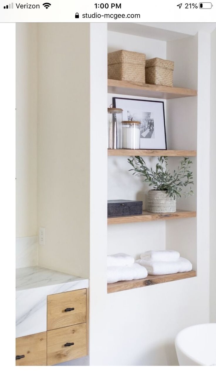 the bathroom is clean and ready to be used as a storage area for towels or other items