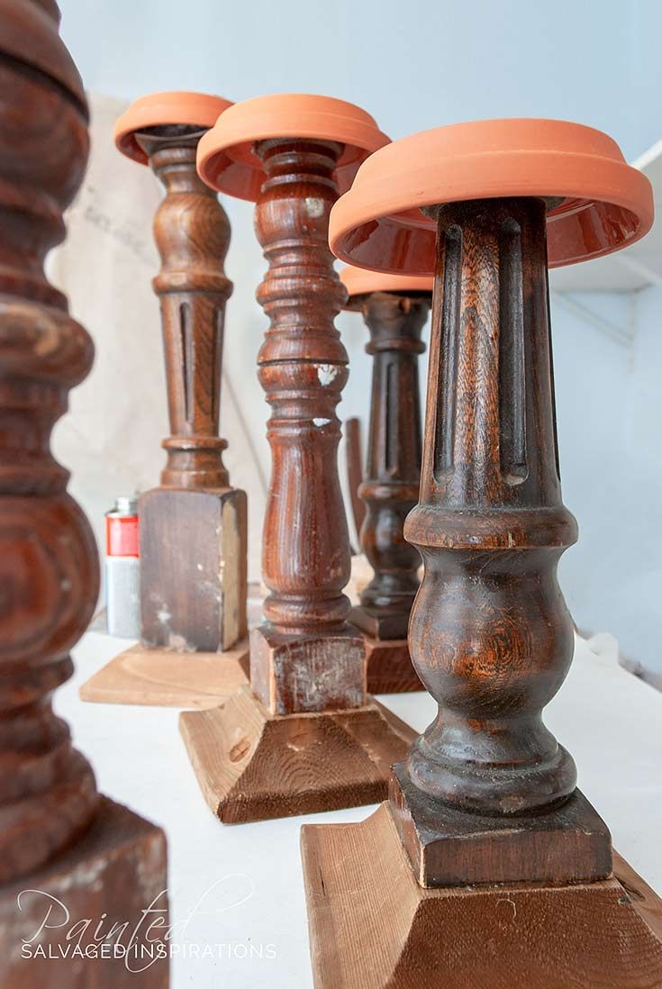 an assortment of wooden candlesticks on display