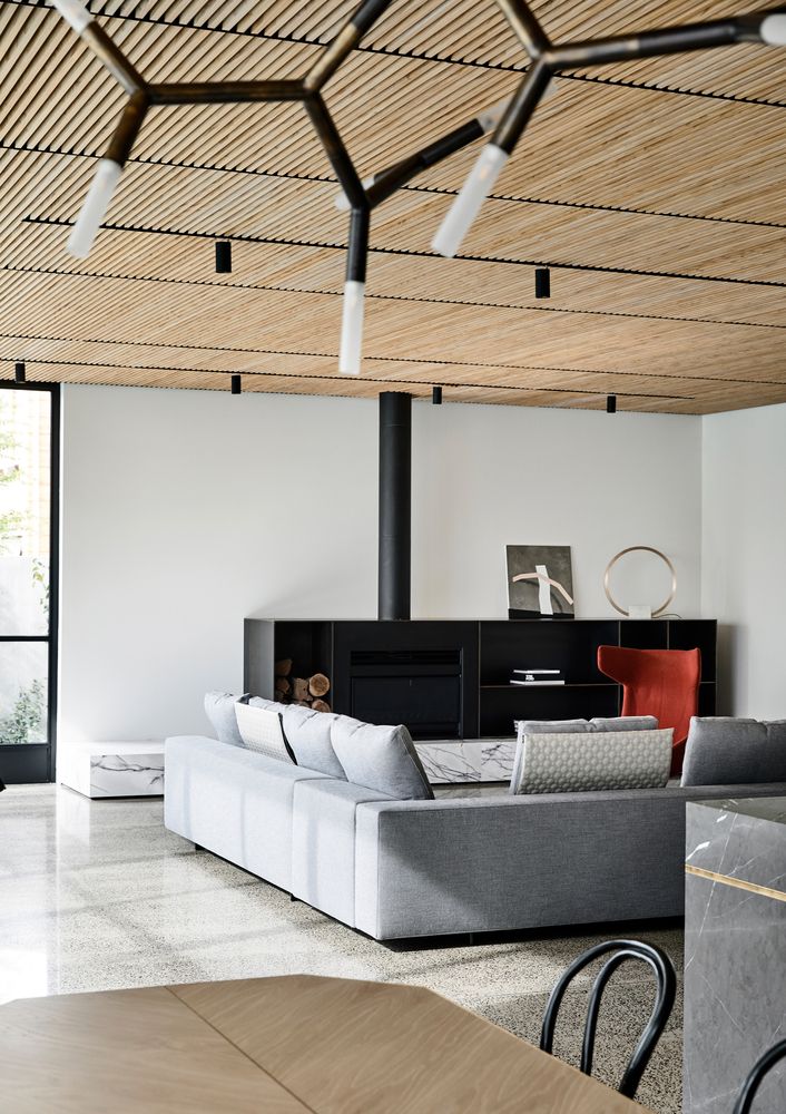 a living room filled with furniture and a fire place in the middle of it's walls