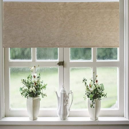 three white vases with flowers are sitting on a window sill in front of the blinds