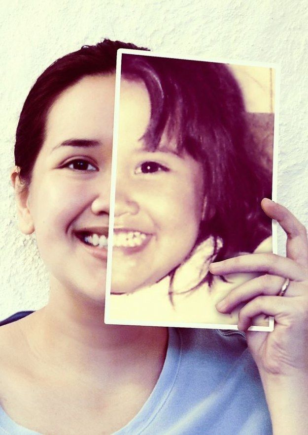 a woman is smiling and holding up a polaroid with the image of her face