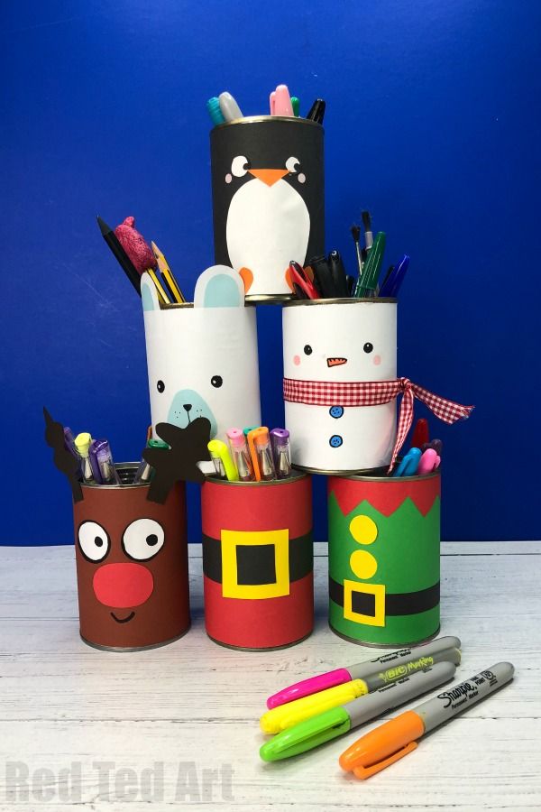 several pencils and markers are sitting in cup holders with penguins, penguin, snowman