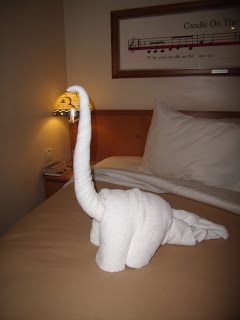 a towel swan on a bed in a hotel room