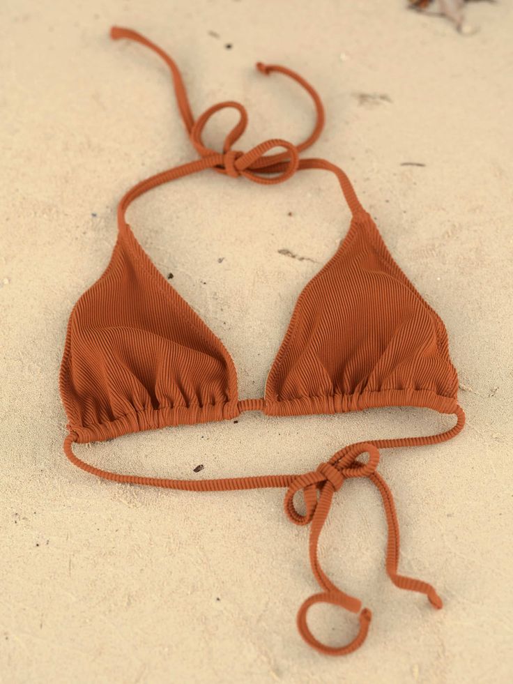 When the sun is out a String Theory Bikini is all you need. Made in Los Angeles with fabric imported from Brazil Fully lined Adjustable Orange Beachwear Swimwear, Orange Adjustable Triangle Top Swimwear, Orange Triangle Halter Top For Beachwear, Fitted Brown Halter Top For Beach, Orange Triangle Top Swimwear For Beach Season, Sand Color Triangle Top Swimwear For Summer, Orange Halter Neck Top For Beach, Fitted Summer Swimwear For Warm Weather, Orange Triangle Top Swimwear For Beach