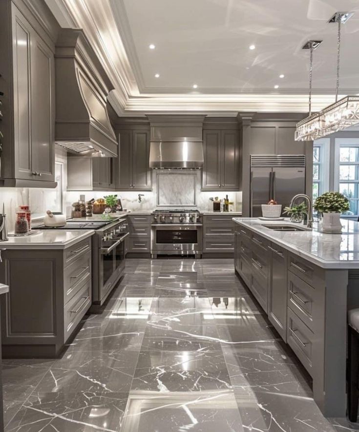 a large kitchen with marble floors and gray cabinets