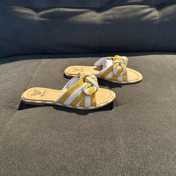 Brand New Women’s Slide Sandals, In Size 6.5. They Fit True To Size And Will Fit A 6 To 6.5. These Are A Boutique Brand Sandal. These Sandals Are Super Cute, With A Gorgeous Knot Detail In Cream And Mustard Colors. These Simple Sandals Will Go With So Many Things And Can Step Up Any Outfit. They Do Have A Little Cushion On The Bottom And Appear To Be Really Comfortable. Perfect For Spring And Summer! Yellow Open Toe Flip Flops For Beach, Yellow Synthetic Flip Flops For Beach Season, Trendy Yellow Flip Flops For The Beach, Trendy Yellow Flip Flops For Beach, Yellow Synthetic Flat Flip Flops, Yellow Flat Synthetic Flip Flops, Yellow Vacation Flip Flops, Yellow Slip-on Beach Sandals, Yellow Slip-on Sandals For Beach