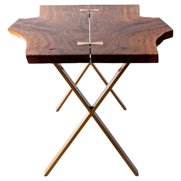 a wooden table with two crossed legs and a cross on the top that is made out of wood