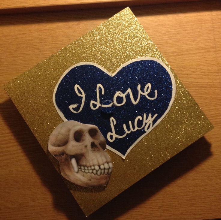 a graduation cap decorated with a skull and i love lucy sticker on the front