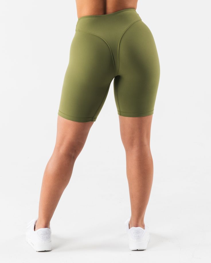 HIGHLIGHTS. 7" inseam High rise Buttery soft High sweat FIT SUGGESTION. This item runs true to Alphalete's tight fit... Brittney is 5’2”/157.5cm, wearing a size S. with 26"/66cm waist and 37"/94cm hips. MATERIALS AND WASHING DIRECTIONS. 70% Nylon, 30% Spandex. We recommend washing inside-out on a cold setting. Hang to dry DESCRIPTION Extreme high stretch meets a buttery soft hand-feel to make this fabric the perfect ten. No front seam and a double layer front panel, for added compression and com Fitted Biker Shorts With 5-inch Inseam For Gym, Athleisure Fitted Leggings With Built-in Shorts, Fitted Green Running Leggings, Green Fitted Running Leggings, Fitted Green Leggings For Running, Green Fitted Leggings For Running, Green Fitted Workout Tights, Sporty Fitted Biker Shorts With 5-inch Inseam, Fitted Green Tights For Workout