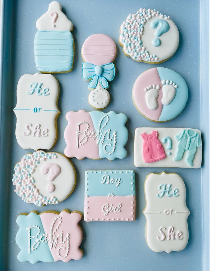 baby shower cookies are arranged on a blue tray