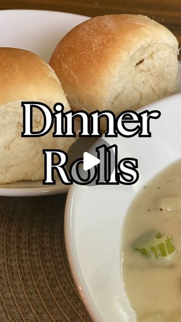 two rolls sitting on top of a white plate next to a bowl filled with soup