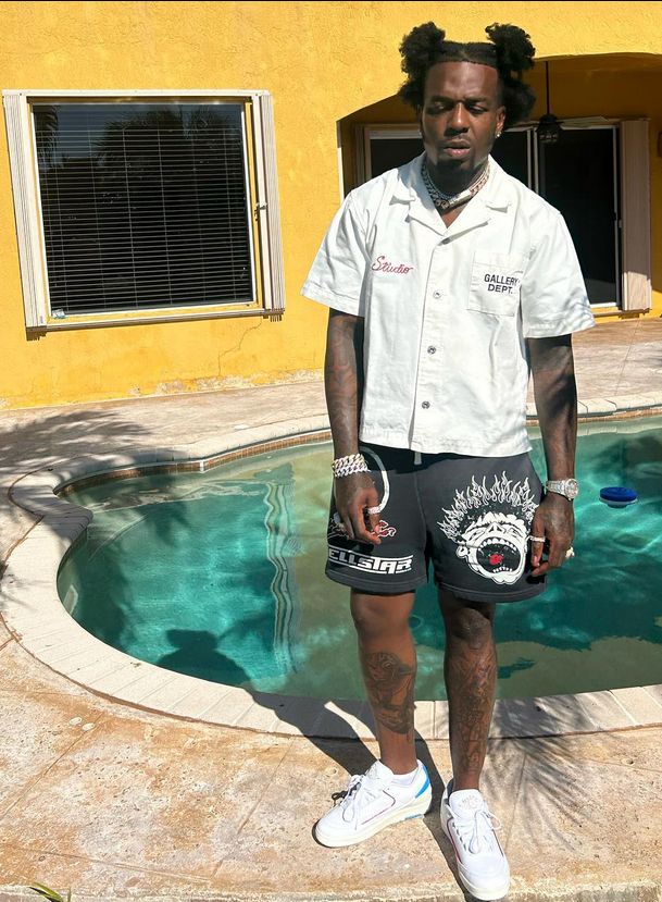 a man standing in front of a swimming pool