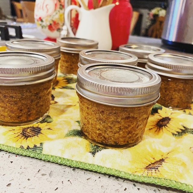 several jars filled with food sitting on top of a table