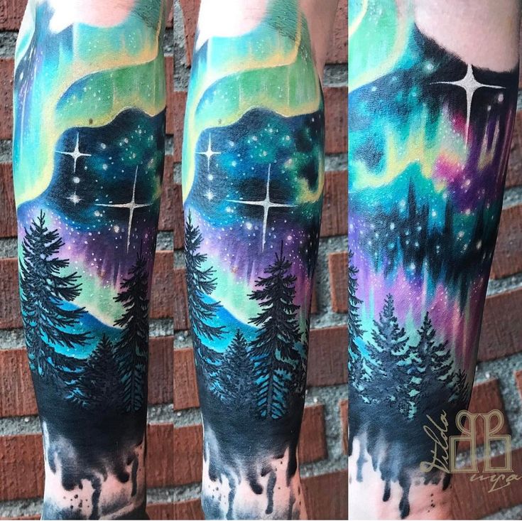 a man's leg with an aurora bore tattoo on it