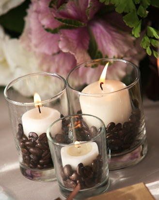 three candles with coffee beans in them on a table