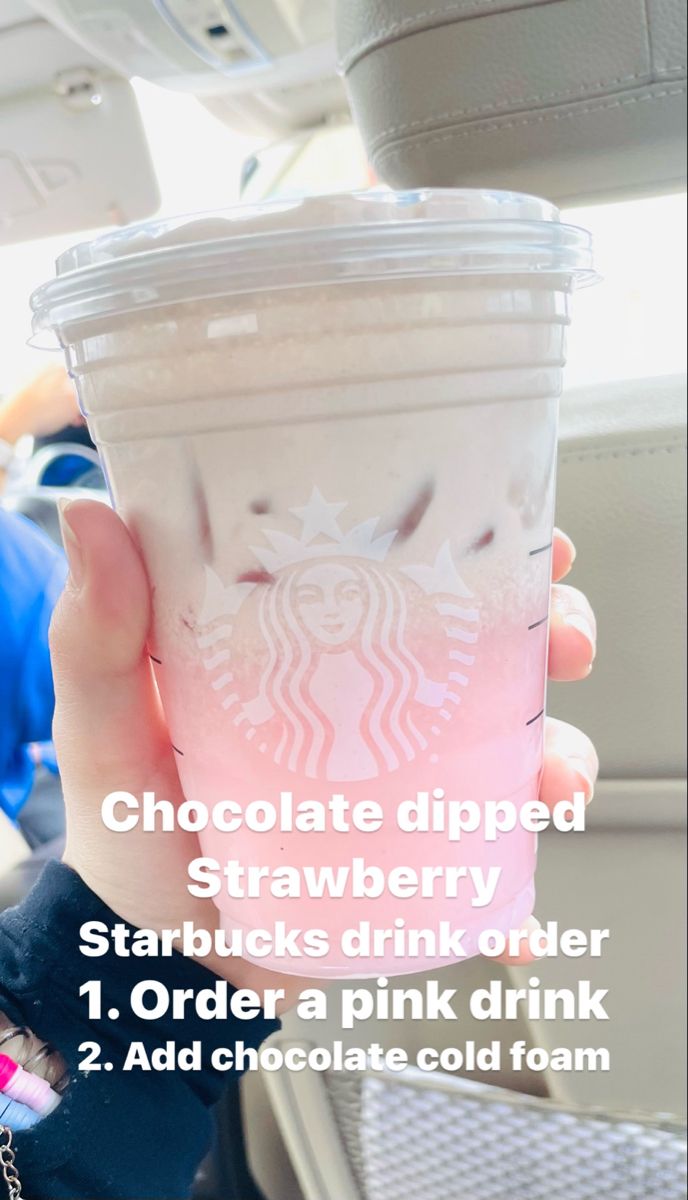 a person holding up a pink drink in their hand with the words chocolate dipped strawberry starbucks starbucks