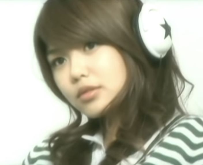 a young woman with headphones on her ears