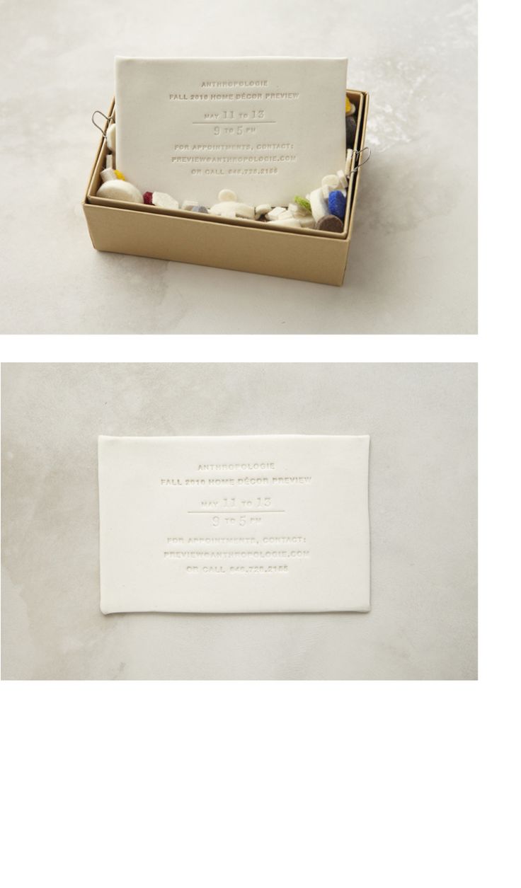 two boxes with business cards in them sitting on a white table top next to each other