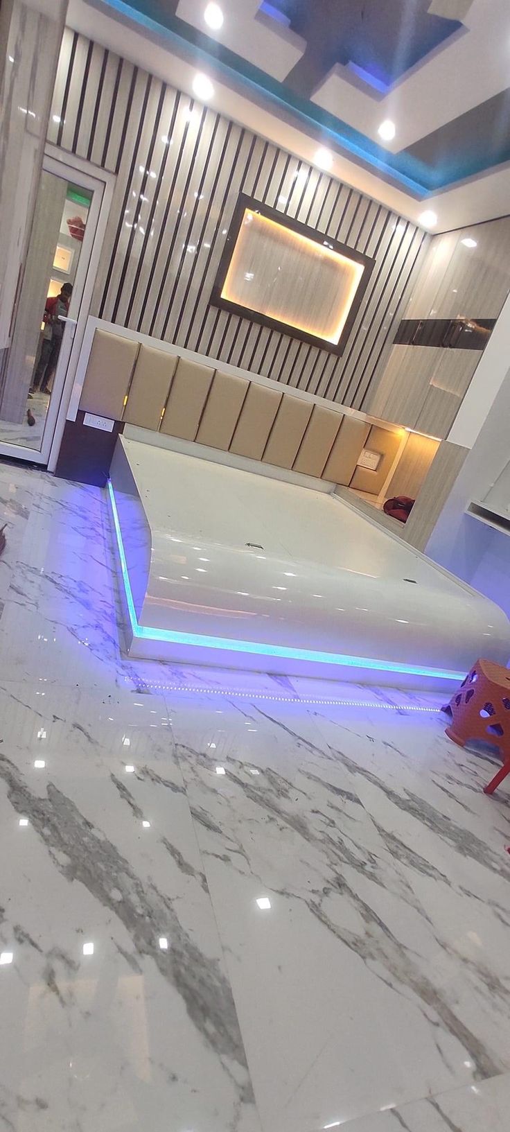 a room with white marble floors and blue lights