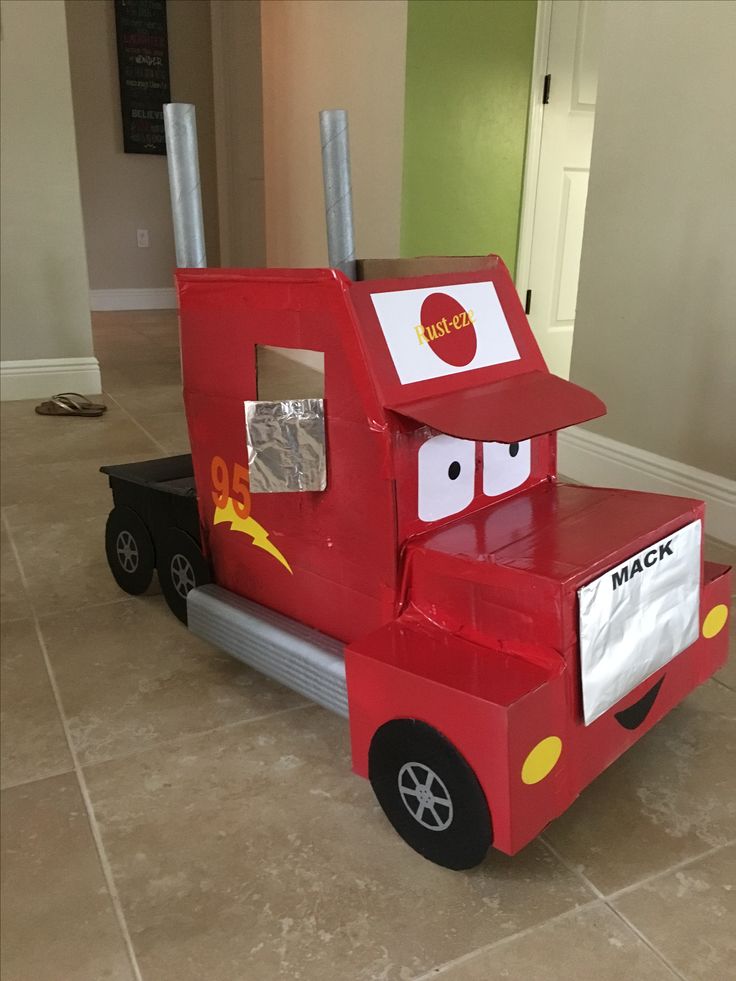 a red truck costume is sitting on the floor