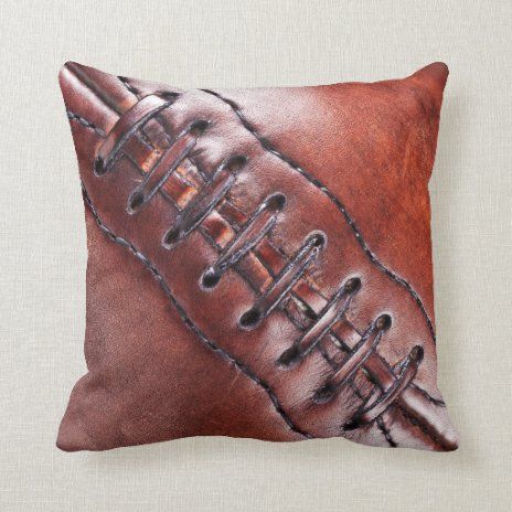 a leather pillow with an image of a baseball on it