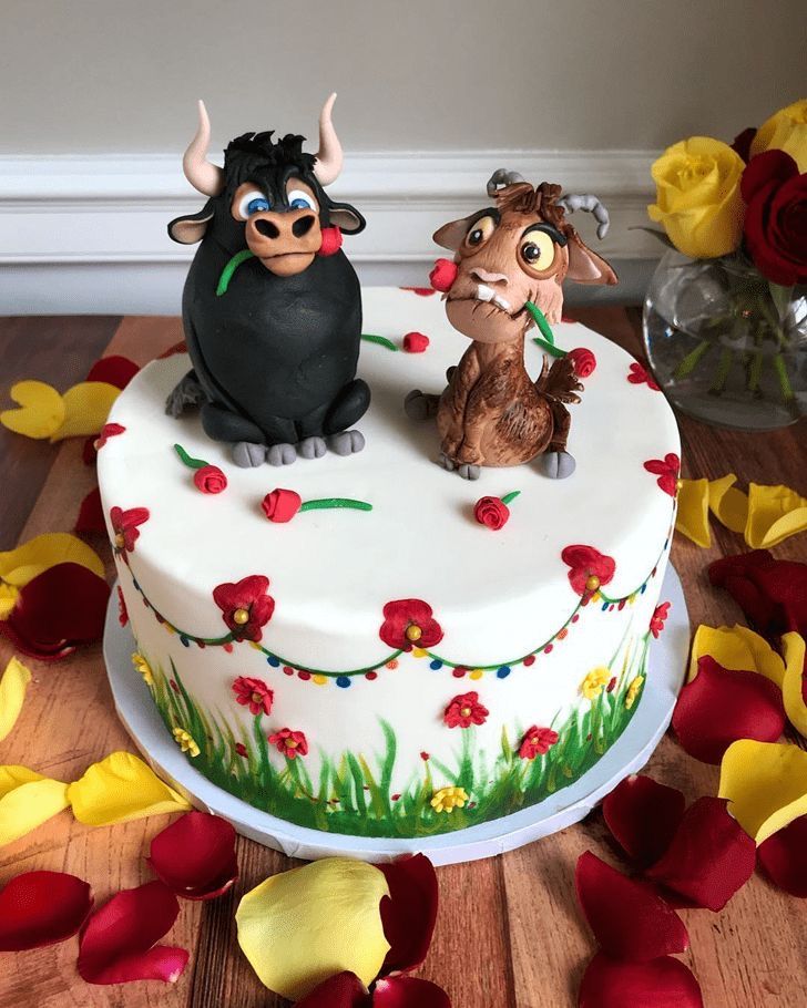 a cake decorated with an image of two cows on top of it and flowers around the edges