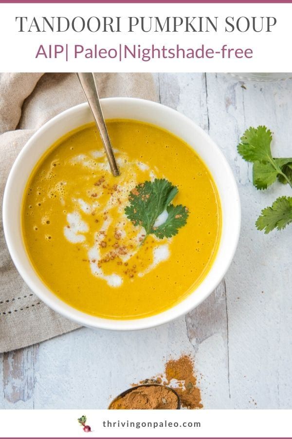 a white bowl filled with soup and topped with cilantro