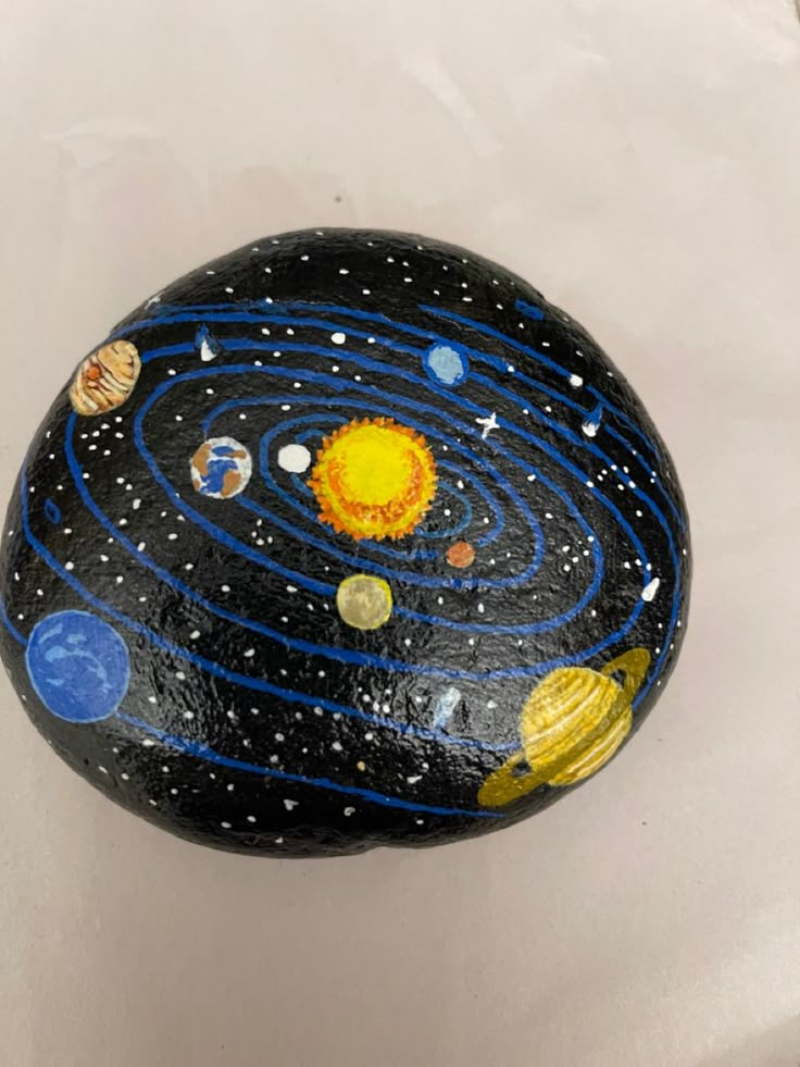 a painted rock with the solar system on it